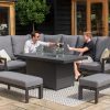Manhattan Reclining Aluminium Corner Dining Set - With Fire Pit Table two people using the sofa set with one serving a drink to another