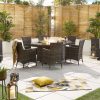 Amelia 6 Seat Dining Set with Fire Pit - 1.8m x 1.2m Oval Table a distant shot of the set